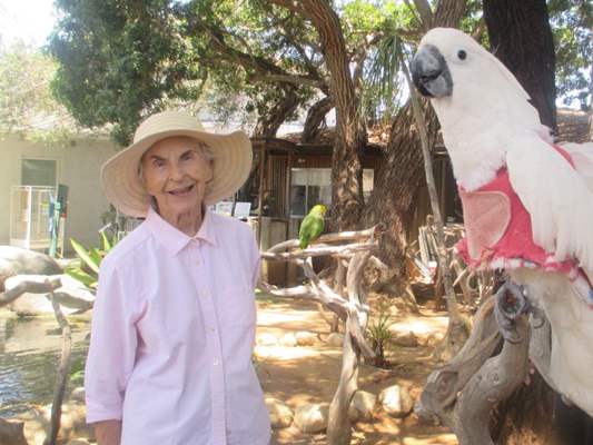 Resident with bird in bird sanctuary