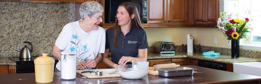 Staff assisting resident in kitchen