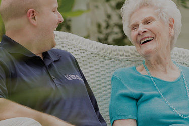 Elderly lady talking to worker