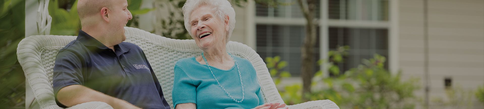 Elderly lady talking to worker