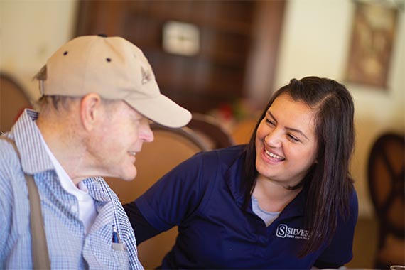 Team member helping elderly man