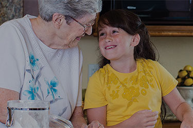 Elderly woman cooking with child