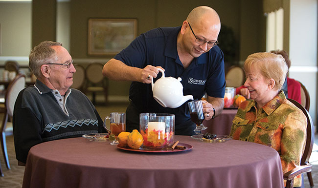 Employee serving residents in dining room